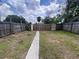 The property features a spacious, fenced backyard offering privacy and plenty of room for outdoor activities at 1413 11Th St, St Cloud, FL 34769