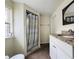 Bathroom features a granite countertop sink with a shower behind a patterned shower curtain at 1413 11Th St, St Cloud, FL 34769