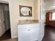 Bathroom with granite countertop sink with white cabinets and access to the adjacent rooms at 1413 11Th St, St Cloud, FL 34769