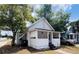 A cozy cottage-style home with a covered porch and mature trees at 1413 11Th St, St Cloud, FL 34769