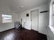 View of a sparsely decorated room with dark-stained floors and exposed water heater at 1413 11Th St, St Cloud, FL 34769