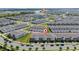 Aerial view of the residential neighborhood with a lake and community amenities in background at 14416 Orchid Island Dr, Orlando, FL 32827