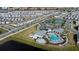 An aerial view of the community featuring a resort-style pool, tennis courts, and playgrounds at 14416 Orchid Island Dr, Orlando, FL 32827