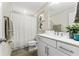 Stylish bathroom showcasing a modern vanity, white cabinets, and a shower with curtain at 14416 Orchid Island Dr, Orlando, FL 32827