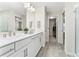 A bright bathroom with a double sink vanity, decorative wall mirror, and a closet at 14416 Orchid Island Dr, Orlando, FL 32827