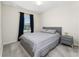Comfortable bedroom featuring soft carpeting, stylish gray furniture, and natural light at 14416 Orchid Island Dr, Orlando, FL 32827