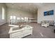 A community room featuring multiple tables, chairs, and a comfortable couch area at 14416 Orchid Island Dr, Orlando, FL 32827