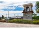 Isles of Lake Nona entrance sign with stone base, water feature, and lush landscaping under sunny skies at 14416 Orchid Island Dr, Orlando, FL 32827