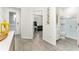 Open entryway with wood-look flooring, leading to a bathroom with a glass-enclosed shower and a living room at 14416 Orchid Island Dr, Orlando, FL 32827