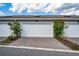 Driveway leading up to the garage with decorative landscaping surrounding it at 14416 Orchid Island Dr, Orlando, FL 32827
