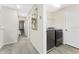 Upstairs hallway featuring carpet flooring, an art piece, and laundry room at 14416 Orchid Island Dr, Orlando, FL 32827