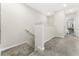 Hallway with carpet flooring, stairs, railing, and doorway to another room at 14416 Orchid Island Dr, Orlando, FL 32827