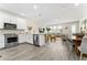 Modern open-concept kitchen with stainless steel appliances and sleek white cabinets, seamlessly connected to the living area at 14416 Orchid Island Dr, Orlando, FL 32827