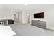 Spacious main bedroom with a king bed, gray dresser, and a comfortable sitting area at 14416 Orchid Island Dr, Orlando, FL 32827