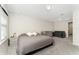 Light filled main bedroom featuring a king bed, crib, and a sitting area with plush sofa at 14416 Orchid Island Dr, Orlando, FL 32827