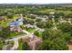 Aerial view of the community showcasing well-maintained homes, lush greenery, and a serene pond at 14610 Wishing Wind Way, Clermont, FL 34711