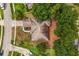 Aerial view of the home displaying the roof, driveway, walkway and surrounding landscaping at 14610 Wishing Wind Way, Clermont, FL 34711