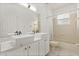 Bathroom featuring double sinks, framed mirrors, and a tub with a shower at 14610 Wishing Wind Way, Clermont, FL 34711