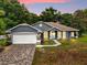 Charming single-story home featuring a brick driveway, well-maintained lawn, and inviting curb appeal at 14610 Wishing Wind Way, Clermont, FL 34711