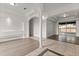 Bright, open-concept living room featuring modern flooring, stylish archways, and sliding glass doors to the patio at 14610 Wishing Wind Way, Clermont, FL 34711