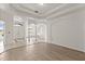 Bright and airy living area featuring arched doorways, tiled and wood-look flooring, and a double-door entryway at 14610 Wishing Wind Way, Clermont, FL 34711