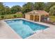 Community pool with a bath house, black aluminum fencing, and a well maintained deck at 14610 Wishing Wind Way, Clermont, FL 34711