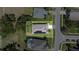 Aerial view of home showcasing a well-maintained roof, solar panels and manicured lawn with clearly marked property lines at 1746 Golfview Dr, Kissimmee, FL 34746