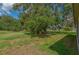 Lush backyard featuring an inviting tree and seating at 1746 Golfview Dr, Kissimmee, FL 34746