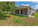 Exterior view of the covered, screened patio and backyard at 1746 Golfview Dr, Kissimmee, FL 34746
