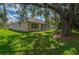 Beautiful backyard with mature trees and green grass at 1746 Golfview Dr, Kissimmee, FL 34746