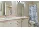 A bright bathroom boasts double sinks, light vanity, and a shower with curtain at 1746 Golfview Dr, Kissimmee, FL 34746