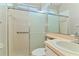 Bathroom features a glass-enclosed shower with a handrail, neutral vanity, and tile floor at 1746 Golfview Dr, Kissimmee, FL 34746