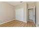 A cozy bedroom features wood floors, a closet, and a doorway to the home at 1746 Golfview Dr, Kissimmee, FL 34746