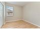 A simple bedroom with wood floors, a window with blinds, and a closet at 1746 Golfview Dr, Kissimmee, FL 34746