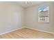 Bedroom features wood flooring, a window with blinds, and neutral-colored walls at 1746 Golfview Dr, Kissimmee, FL 34746