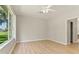 Bedroom with wood floors, ceiling fan and view at 1746 Golfview Dr, Kissimmee, FL 34746