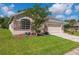 Charming single-Gathering home featuring a stone facade, manicured lawn, and two car garage at 1746 Golfview Dr, Kissimmee, FL 34746