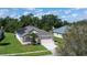 Well-manicured front yard with an aerial view of the home's exterior at 1746 Golfview Dr, Kissimmee, FL 34746