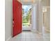 Open foyer with a red front door and tiled flooring, showcasing a bright and welcoming entrance at 1746 Golfview Dr, Kissimmee, FL 34746