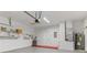 Spacious garage with storage shelves, water heater, red accent, and a garage door opener at 1746 Golfview Dr, Kissimmee, FL 34746