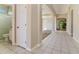 Bright hallway with tiled floors leading to the living area and bathroom with a glass shower at 1746 Golfview Dr, Kissimmee, FL 34746