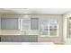 Modern kitchen with gray cabinets, stainless steel appliances, and bright natural light at 1746 Golfview Dr, Kissimmee, FL 34746