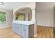 Kitchen with breakfast bar and view into the living room with outside access at 1746 Golfview Dr, Kissimmee, FL 34746