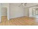 Empty living room showing wood floors and open doorway to the adjacent tile-floored space at 1746 Golfview Dr, Kissimmee, FL 34746