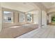 Spacious living room with plush carpet, large windows, and stylish architectural columns at 1746 Golfview Dr, Kissimmee, FL 34746
