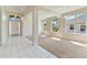 Open living space with tiled entry, large windows, and carpeted living area for a bright, airy feel at 1746 Golfview Dr, Kissimmee, FL 34746