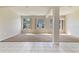 Bright living room with large windows, plush carpet, and stylish columns to the adjacent dining area at 1746 Golfview Dr, Kissimmee, FL 34746