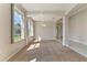 Inviting living room with carpeted floors and large windows, seamlessly connecting to the dining area at 1746 Golfview Dr, Kissimmee, FL 34746