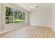 Bright room featuring a large window overlooking a manicured yard at 1746 Golfview Dr, Kissimmee, FL 34746