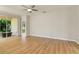 Spacious living room with wood floors, ceiling fan, and sliding glass doors to the outside at 1746 Golfview Dr, Kissimmee, FL 34746